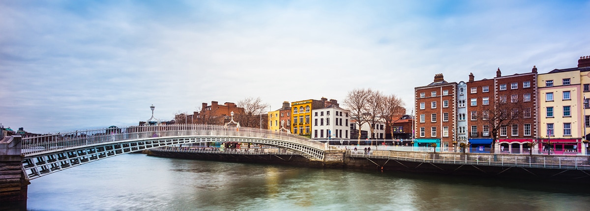 view of the ha'penny bridge and colorful buildings in dublin, ireland